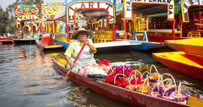 In the area of Xochimilco, Mexico City, locals transport flowers through their canals.