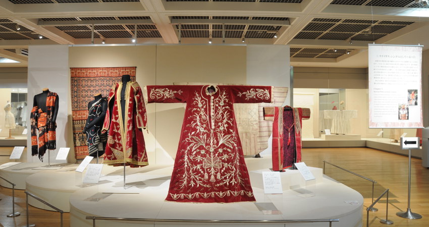 In the picture, traditional tunics of Imperial Japan, those closest to the camera richly embroidered in gold on red velvet